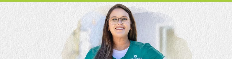 smiling female nursing student wearing scrubs