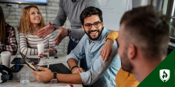 Colleagues laugh and talk during a training and development program