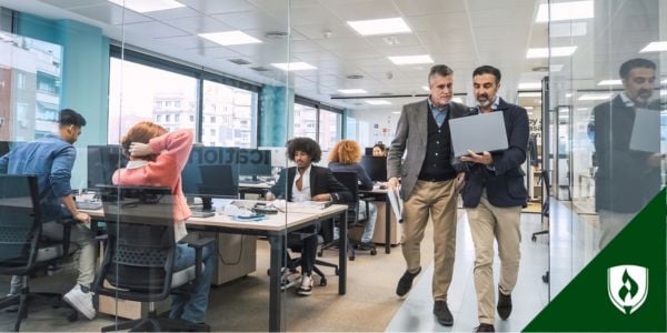 A busy office shows many people working