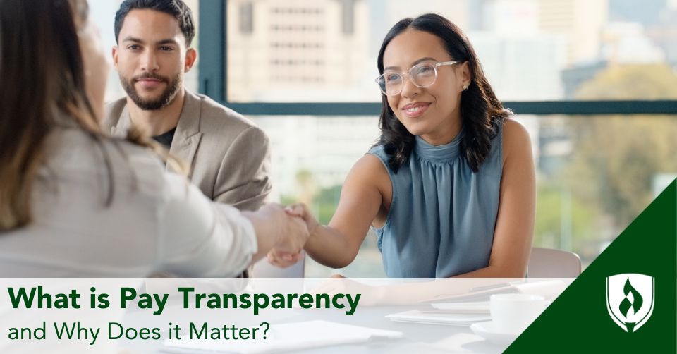 pay transparency header An HR representative shakes hands with a job applicant