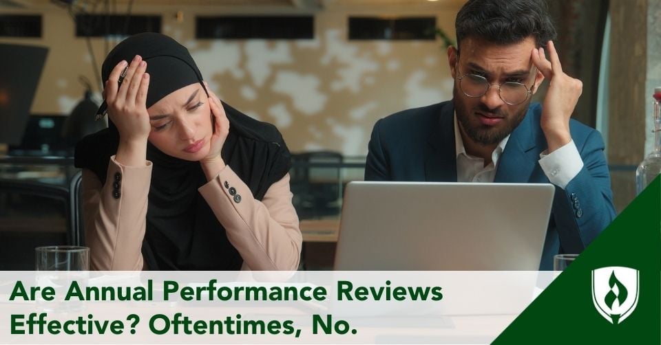 Two frustrated professionals stare at their performance reviews