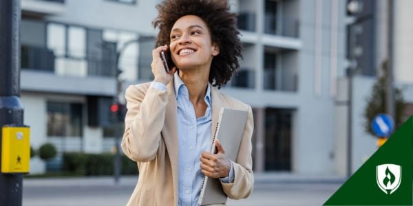 A confident finance major walks while talking on the phone