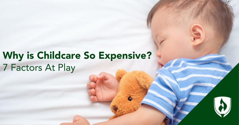 Why is childcare so Expensive Header A sweet baby asleep on white sheets with a teddy bear.